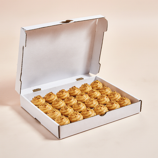 Fresh pistachio profiteroles topped with crushed pistachios from The Happy Family Bakery