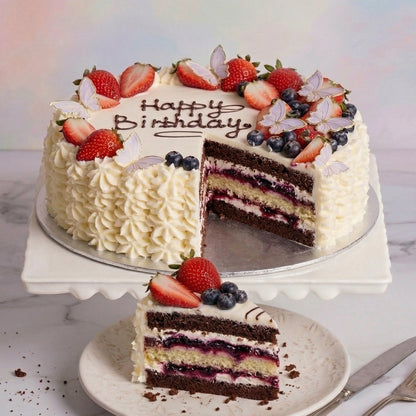 Round decorated Cream & Berry Celebration Cake with a raspberry base from the Happy Family bakery