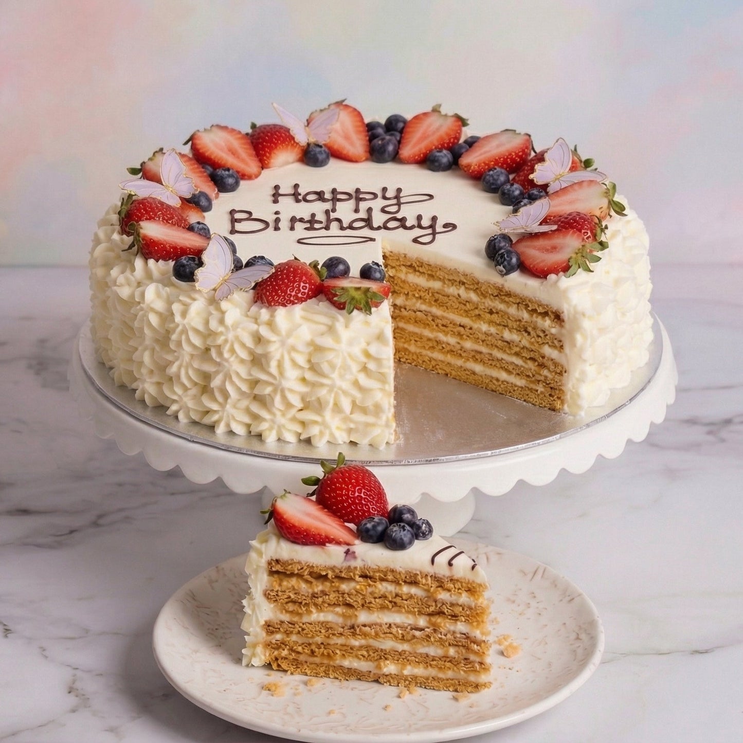 Round decorated cream and berry festive cake with a honey Oreo cake base from the Happy Family bakery